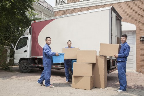 Van loading service with moving boxes and a driver preparing for collection