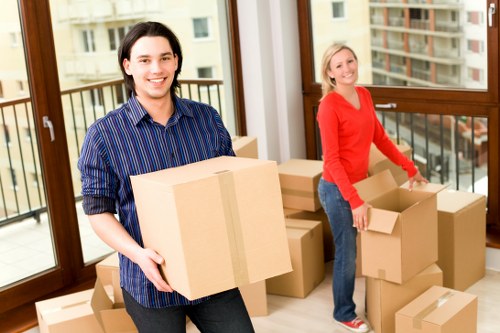 Local movers handling furniture and boxes for a house relocation